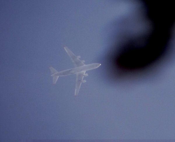 At first glance I thought it might be a 747, how nice to see it was an An 124. Caught the very last moment - the dark area is leaves of a tree.