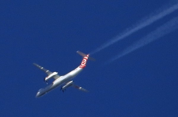 Also with contrails, this Dash 8 is from EuroLOT. Taken from some distance on an eastern heading.