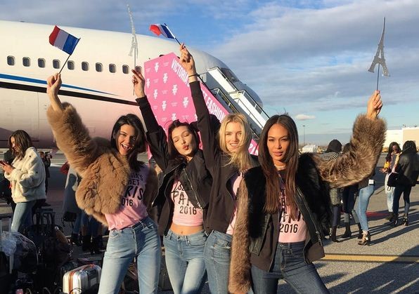 The Victoria's Secret angels pose for a photograph before boarding their flight to Paris